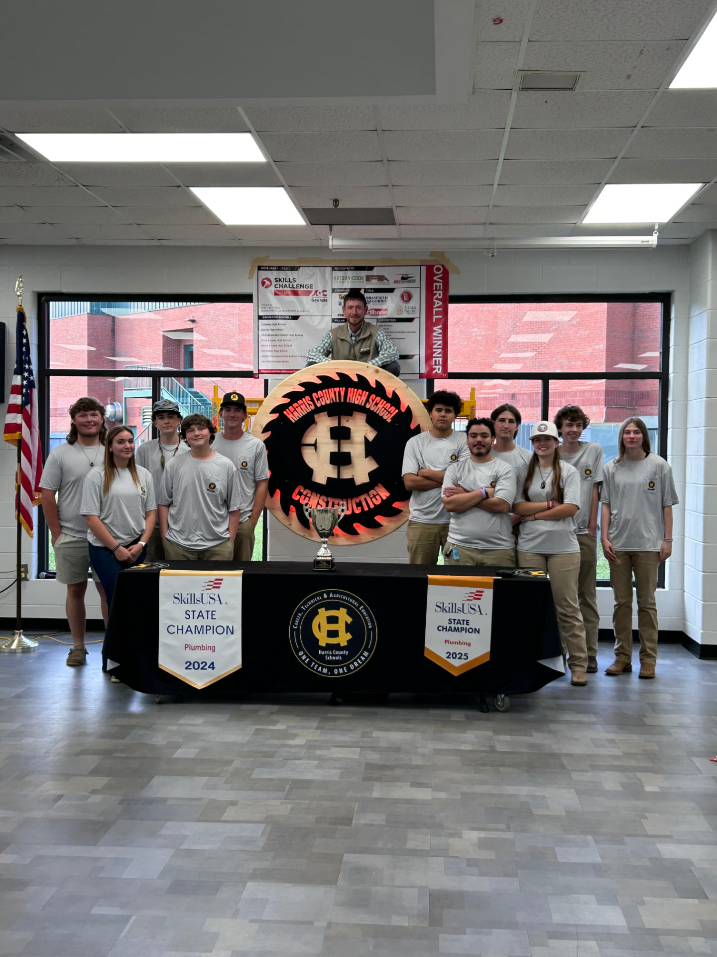 Harris County High School construction students and instructor with SkillsUSA state champion banners and a trophy