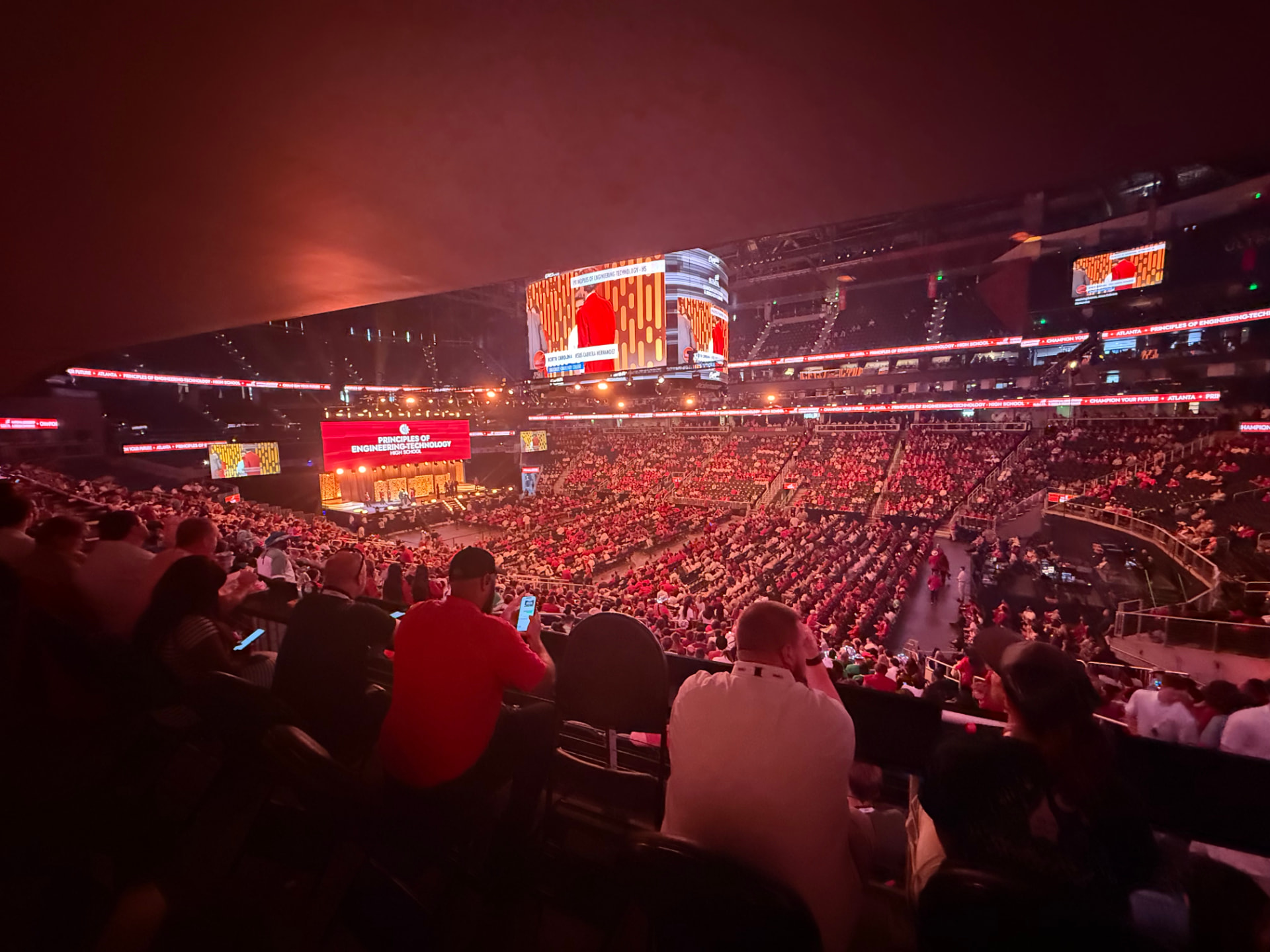 Packed arena during a SkillsUSA national general session with the jumbotron lit up