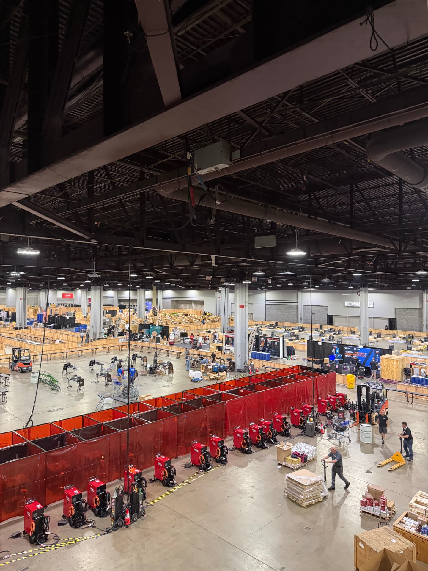 Elevated view of a national competition hall with rows of curtained contest bays