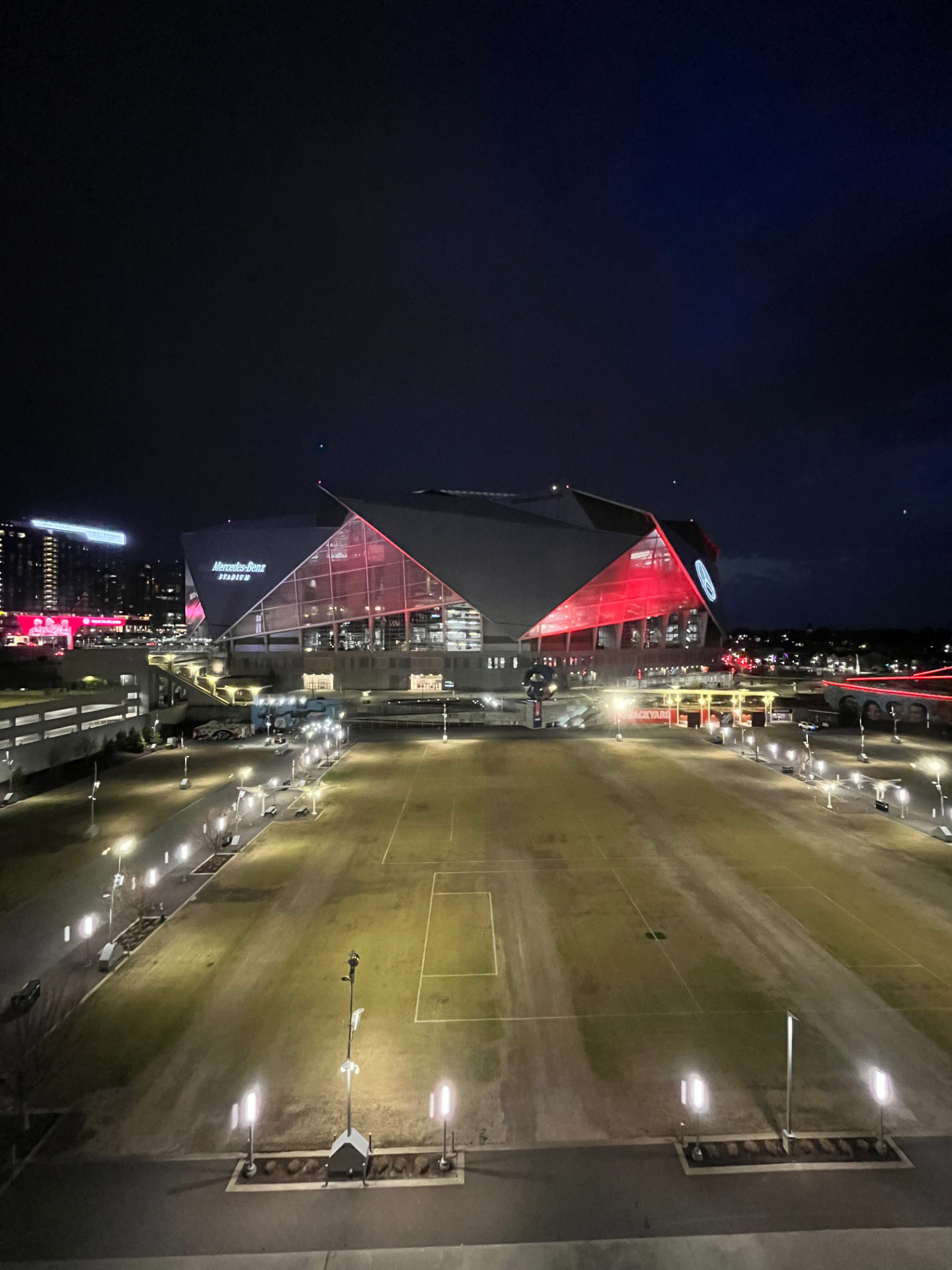 Aerial night view of Mercedes-Benz Stadium in Atlanta lit in red