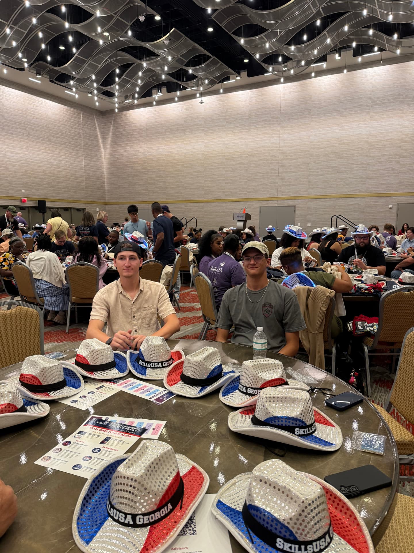 Members at a table covered in sequined SkillsUSA conference hats